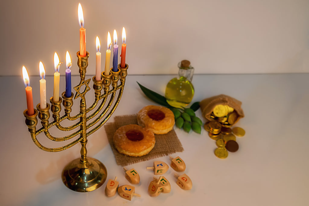 image of lit menorah and other Hanukkah items