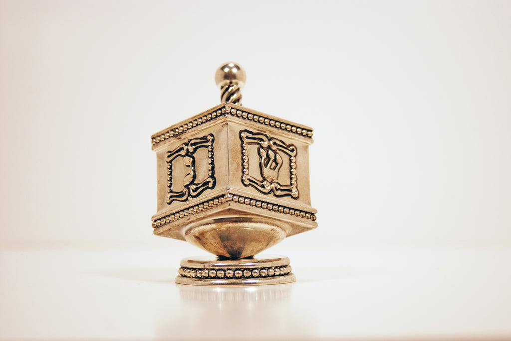 image of old gold colored dreidel